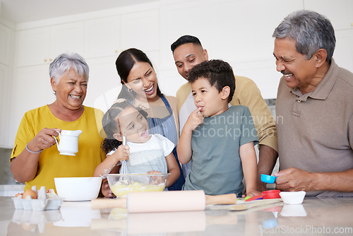 Image of Children, baking and family with a boy tasting flour while learning to bake in the kitchen with parents, grandparents and sister. Kids, learning and love with a girl and boy cooking with relatives