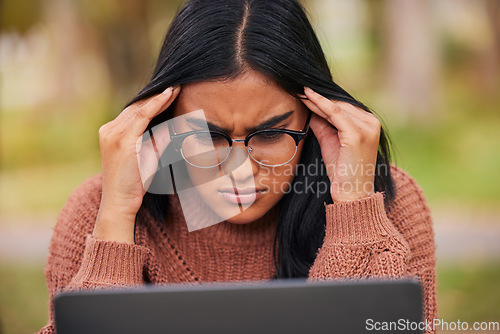 Image of Study, university and laptop student stress at campus with anxiety for a test. Scholarship woman with headache, frustrated and studying outdoor. Burnout in education, learning and confused about exam