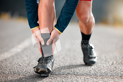 Image of Run injury, feet and sport runner athlete on a outdoor road feeling ankle and sports pain. Leg muscle strain accident from sports training, running and workout exercise busy with fitness cardio