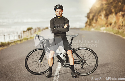 Image of Man, cycling and mountain bike with arms crossed for sports exercise, training and fitness in nature. Portrait of a confident male professional cyclist standing by a bike for cycle tour outdoors