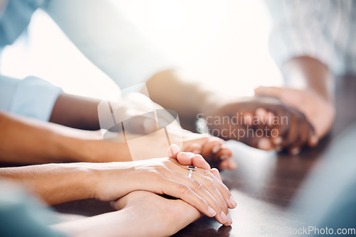 Image of Diversity, hand holding and support for trust, community and hope in unity or teamwork together indoors. Hands of people in collaboration, solidarity and faith for group meeting, therapy and care