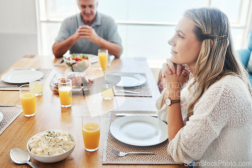 Image of Woman, thinking at the dinner table in gratitude for food, family and home. Female sitting in thought with father in hope, spiritual and religion for grateful thanksgiving meal together