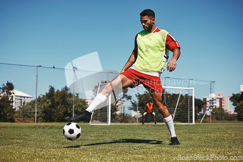 Image of Soccer, sports and game energy of a man athlete from Israel in a fitness workout and training kick. Exercise, football and healthy cardio of a person with match focus on field grass in summer