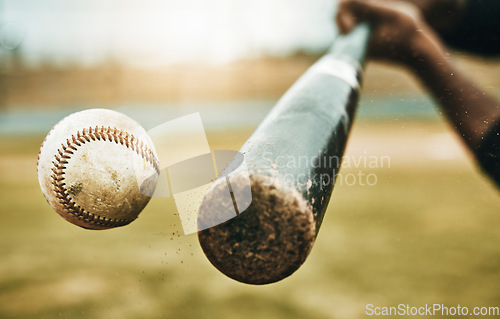 Image of Baseball hit, sports and athlete on a outdoor field hitting a ball in a game with a baseball bat. Sport, baseball player and man busy with exercise, fitness and workout training on green grass