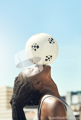 Image of Soccer, ball and head balance of a black woman doing fitness outdoor for sports. Football, exercise and workout training before a game with calm, mindfulness and relax athlete for health