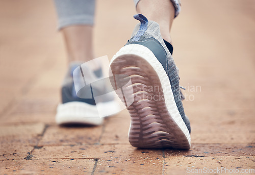 Image of Runner, shoes and outdoor walk of a woman feet before fitness, workout and running exercise. Sport training, foot walking and healthy cardio of a person on a brick pavement ready for a sports run