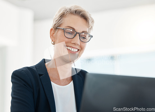 Image of Laptop, management and design with a female CEO, manager or boss working on a project in her office. Computer, creative and typing with a mature business woman or designer at work in her company