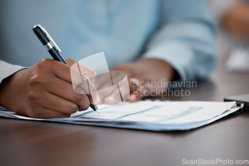 Image of Hands, documents and contract with a black man signing paperwork at a table or desk in the office. Compliance, loan and insurance with a male putting his signature on a legal document for agreement