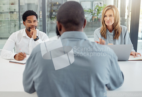 Image of Interview, recruitment or hiring with hr team in meeting with job seeker, professional or unemployed man in company office. Business people listen to question, negotiation or answer of person for job