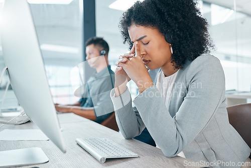 Image of Call center, headache and worker with stress while consulting, working and thinking with burnout at telemarketing company. Sad, frustrated and customer service employee with depression working in crm