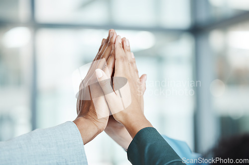 Image of Hands, high five and motivation with a team working in collaboration together in the office. Team building, success and partnership with an employee group in celebration of reaching a target or goal