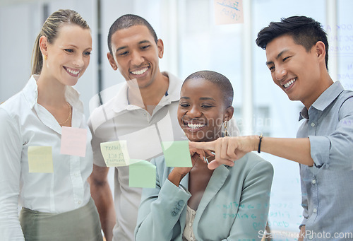 Image of Business people, sticky notes or strategy planning on glass wall in creative marketing office, advertising or growth schedule. Smile, happy or teamwork diversity collaboration thinking of brand goals