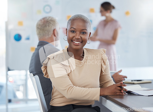 Image of Portrait, black woman and business with smile, being confident and in meeting for planning, startup company and at desk in office. Female, girl and working with coworkers, strategy and documents.