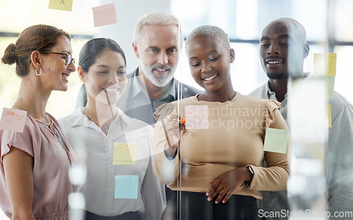 Image of Business people, team and sticky notes for planning, strategy or brainstorming meeting together at the office. Diverse group of creative workers in collaboration for ideas, pages or schedule tasks.