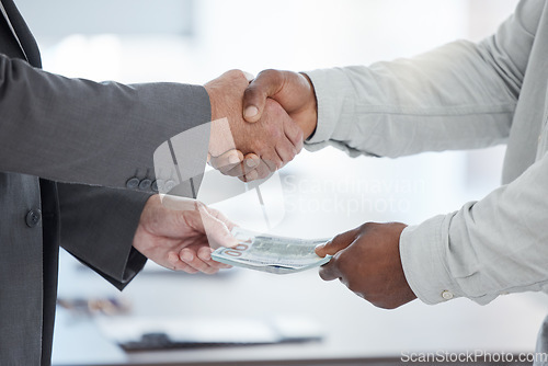 Image of Handshake, money and crime with a business man taking a bribe in the office for a deal or agreement. Finance, payment and fraud with a male employee shaking hands in a partnership of corruption