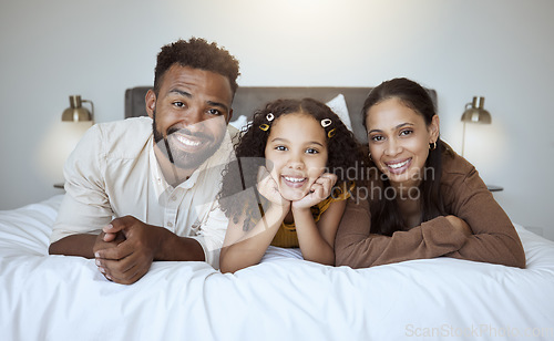 Image of Black family bed, bonding and love of a mother, father and girl on a home bedroom together. Portrait of a happy mama, dad and child in the morning feeling happiness smile feeling care in a house