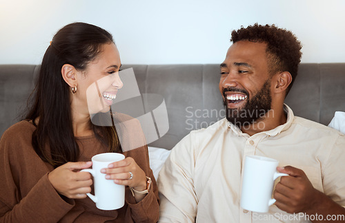 Image of Couple, coffee and laughing people feeling happiness in a home living room lounge sofa. Happy, funny and smile in the morning of a girlfriend and boyfriend together on a house couch with quality time