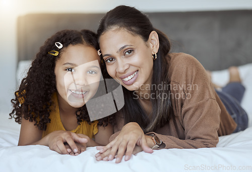 Image of Mother, girl and happy family home morning on a bedroom bed feeling family love and care. Portrait of a mama and child in a house bonding together with a smile lying with happiness smiling content