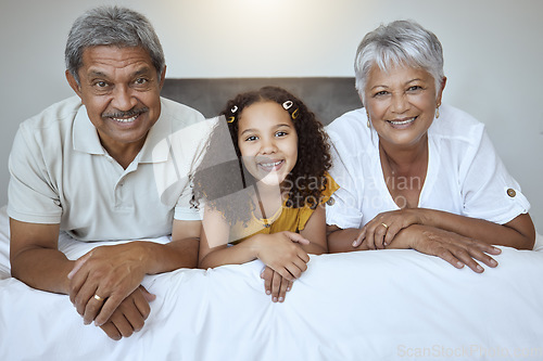 Image of Happy, grandparents and child lying on bed with smile for family bonding, retirement and relax at home. Portrait of little girl, grandma and grandpa smiling in bedroom relaxing together for childcare