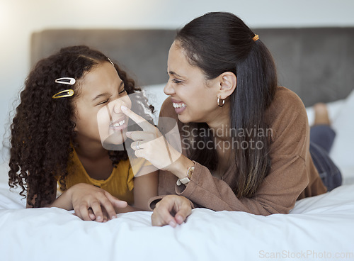 Image of Mother, girl and bonding on a home bedroom bed feeling happy, silly and family care. Mama and child spending quality time together with happiness in the morning in a house feeling comic and funny
