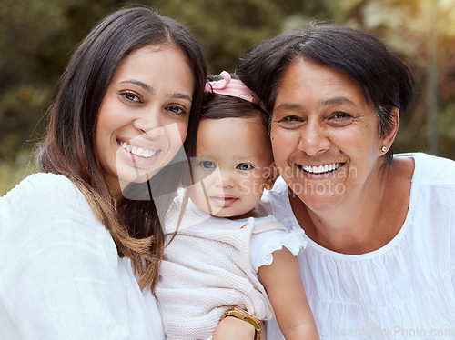 Image of Mother, baby and family bonding outdoor with a smile, love and care in a nature park. Portrait of women generations, mama and elderly woman holding a young girl feeling happy with quality time