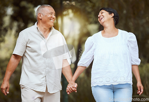 Image of Happy, support and love senior couple enjoy a romantic walk at the forest together on a sunny day. Smile affectionate husband and wife holding hands bonding on vacation and retirement outdoor