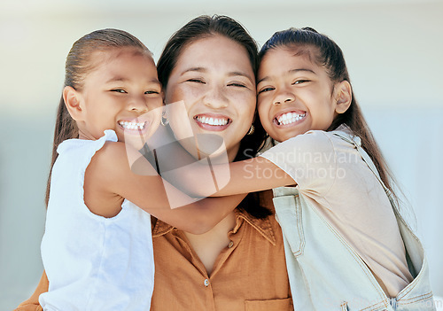 Image of Happy family, mother and girls hug in portrait, bonding and .enjoying quality time together. Family, love and care of mom, woman and parent with kids, smiling and laughing, embrace and comic smile.