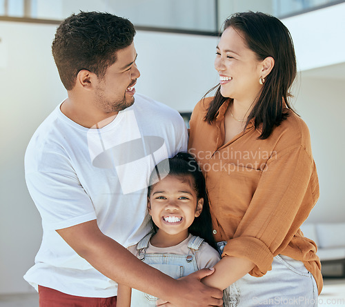 Image of Happy, love and family with a smile at their house standing, embracing and bonding together outdoors. Happiness, mother and father holding their with a girl child with care outside of their new home.