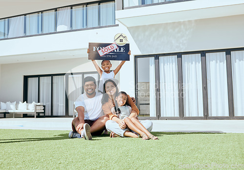 Image of Property, happy family and sold sign with smile, relax and excited people rest, sit and bond on grass. Real estate, house sale and family moving into new home together, joy and carefree relocating