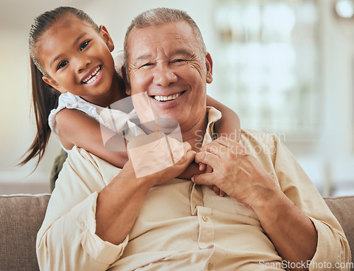 Image of Grandfather, child and portrait with hug in home lounge to bond with young and cute grandchild. Family, elderly and senior grandpa in Indonesia holding kid with happy smile on sofa in house.