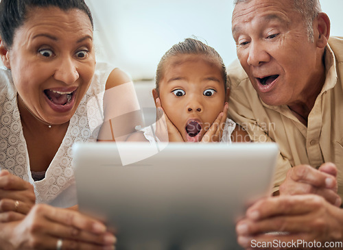 Image of Tablet, family and shocked face child look at video online bonding together at home. Wow grandparents, young girl and fun activity streaming movie or excited news on digital device in living room