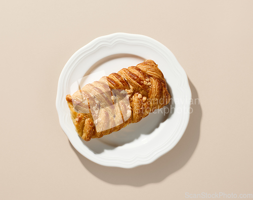 Image of freshly baked sweet bun on white plate