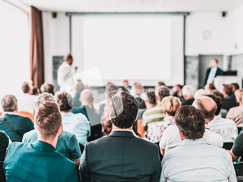 Image of I have a question. Group of business people sitting in conference hall. Businessman raising his arm. Conference and Presentation. Business and Entrepreneurship