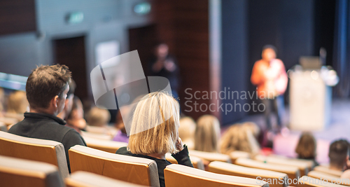 Image of Woman giving presentation on business conference event.