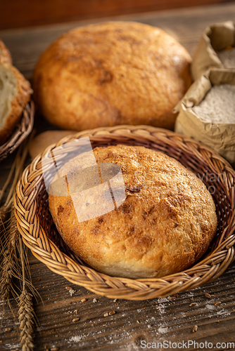 Image of Whole fresh bread in wicker basket