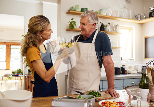 Image of Senior, couple and wine in kitchen, toast and love while cooking, food and bonding in home. Elderly, man and woman with happiness, glass and smile for drinking, romance and happy for alcohol in house