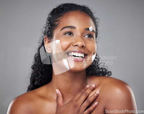 Image of Skincare, beauty and face cream by black woman in studio mockup for wellness, hygiene and grooming. Black woman, facial and skin health by model smile, relax and enjoy treatment on grey background