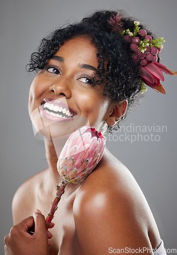 Image of Protea flowers, happy woman and natural beauty, glowing skincare and organic eco makeup, aesthetic wellness or floral perfume on studio background. Happy young model face, plants and herbal cosmetics