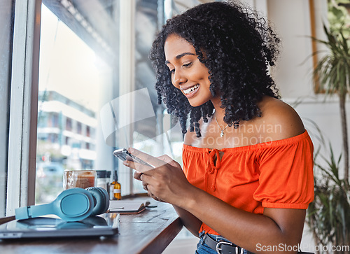 Image of Coffee shop, black woman and phone while happy, excited and typing on phone for communication app with cafe wifi. Freelancer female on internet to blog, social media and do remote work on internet