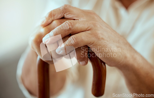 Image of Senior man hands, walking stick and disability, retirement and osteoporosis, arthritis and injury. Wooden cane of elderly, disabled and old patient support, healthcare and sick help in nursing home