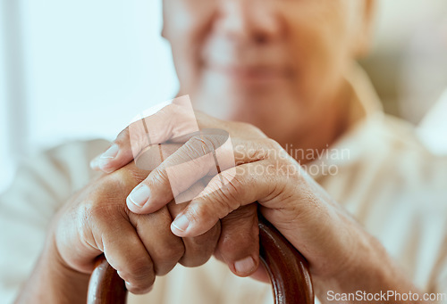 Image of Senior man, hands and cane for disability, arthritis or osteoporosis in home. Closeup, retirement and disabled elderly male holding wooden walking stick for support, aging or help and assistance.