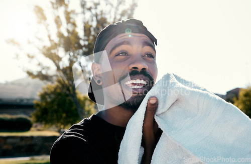 Image of Black man, face and towel while outdoor for fitness, health and exercise in park, street or town. Man, young and gen z in summer, sunshine or trees with cloth for dry, sweat or skin in Los Angeles