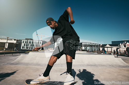 Image of Black man, skater on skateboard and skate trick in a park in Los Angeles California summer sun for fitness, exercise and fun. Extreme sports athlete, cardio workout and skating competition training