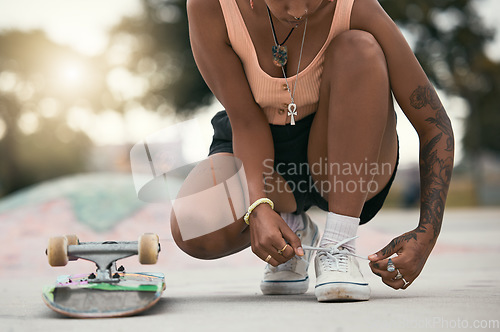 Image of Skater, shoes and tying laces with skateboard in park to skate for fun, exercise and training outdoors. Fitness, woman athlete and sports sneakers on feet in park during summer vacation or adventure.