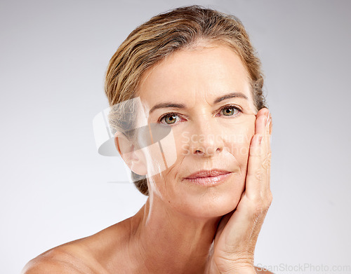 Image of Face, beauty and antiaging with a mature woman in studio on a gray background for skincare or wellness. Cosmetics, health and treatment with a senior female posing to promote a natural product