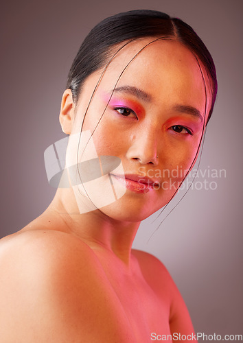 Image of Futuristic makeup, asian beauty and woman in studio portrait with neon light for cosmetics product advertising. Japanese or Korea girl model headshot or face with vaporwave future cosmetic mock up
