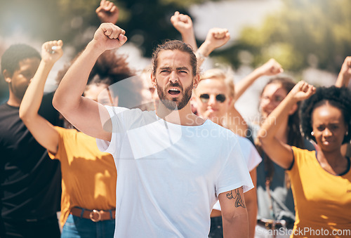 Image of Diversity, people and protest voice opinion in a city with fist and arms in the air for justice or equality. Crowd of freedom event in streets for power, community and social opinion with motivation