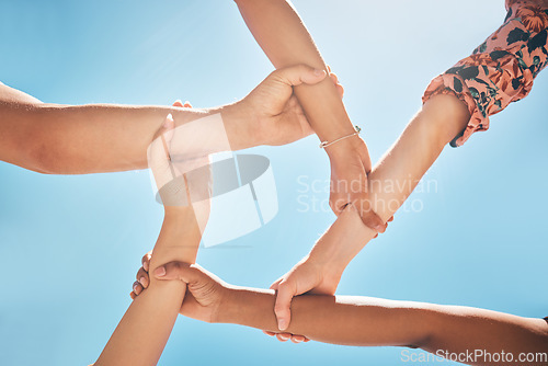 Image of Team of people support, hands connect or link together global community of cooperation on blue sky. Group diversity in volunteer partnership, social solidarity or multicultural friends of circle arms