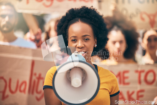 Image of Protest, loud speaker and rally with a woman activist speaking during a march for equality in the city. Freedom, speech and community with a young female protestor in fight for human rights