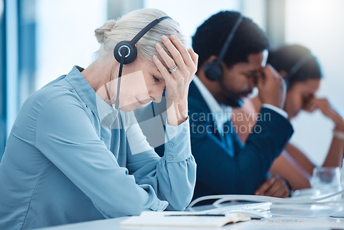 Image of Telemarketing team, customer service employees and stressed crm workers at office desk. Senior business woman burnout, call center compliance consultant agent and stress headache on call with headset